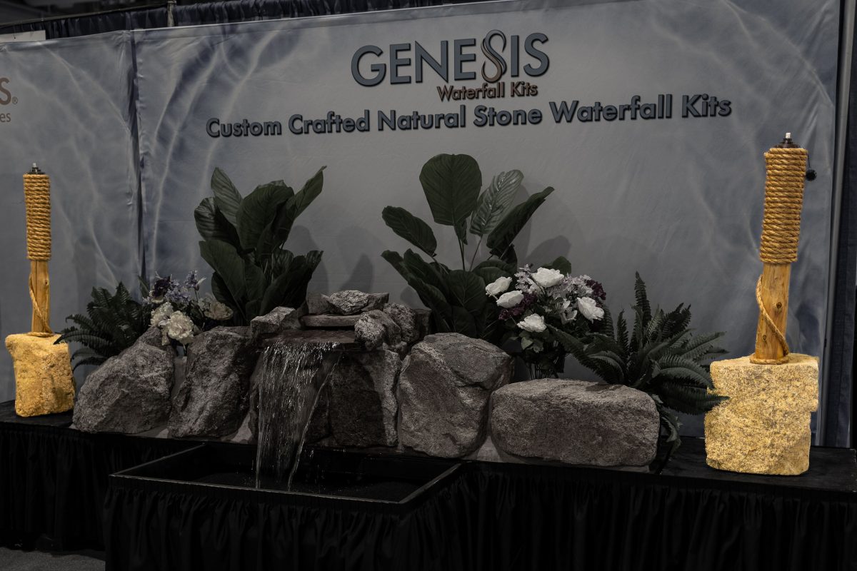 A pair of natural stone tiki torches accenting a natural stone waterfall