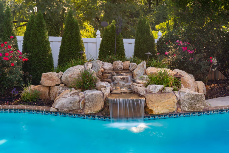Natural stone waterfall renovation on an existing swimming pool