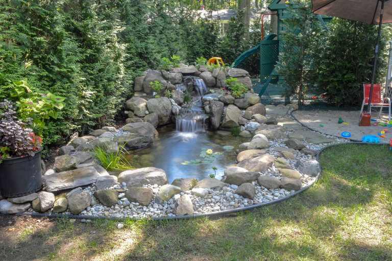 Natural stone pond and standalone waterfall system