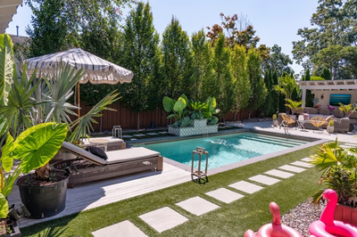 Single-tier sheer descent waterfall flowing from a tiled planter into a rectangular pool