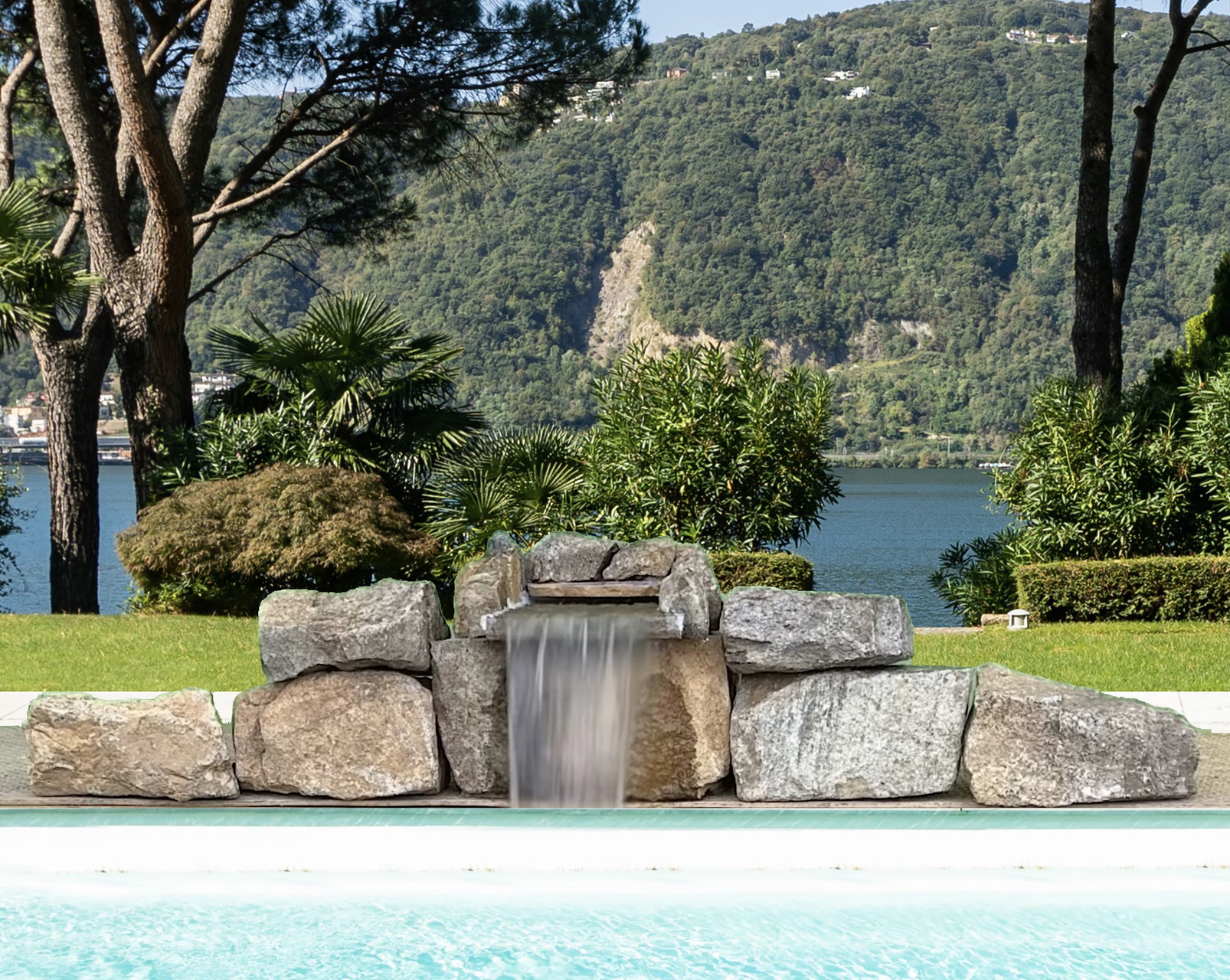 Genesis natural stone pool waterfall kit by Advanced Waterfall Systems installed on an inground pool