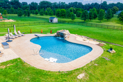 Patterson K - Medford, NJ - A large backyard with a swimming pool and a waterfall.